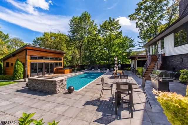 a view of a patio with table and chairs potted plants and a large tree