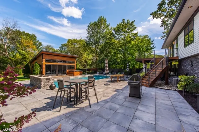 a view of a patio with table and chairs and potted plants