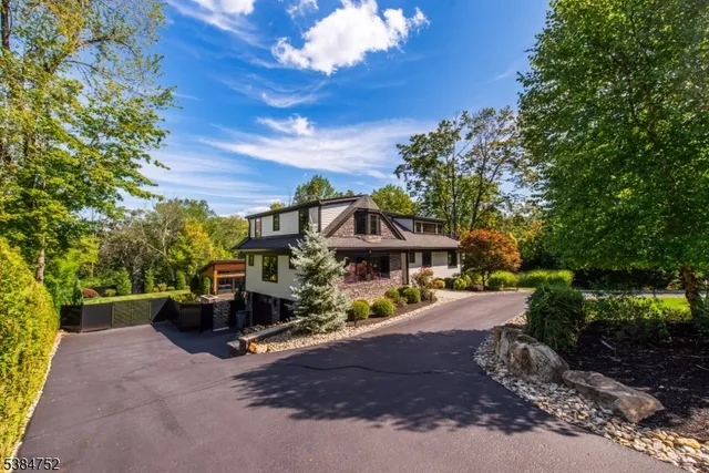 a view of a house with a large tree and a yard