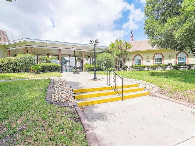 a view of a house with swimming pool and a yard