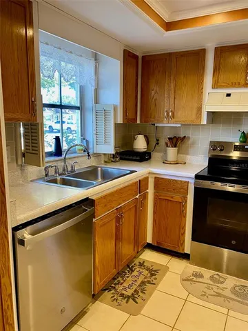 a kitchen with a sink stove and cabinets