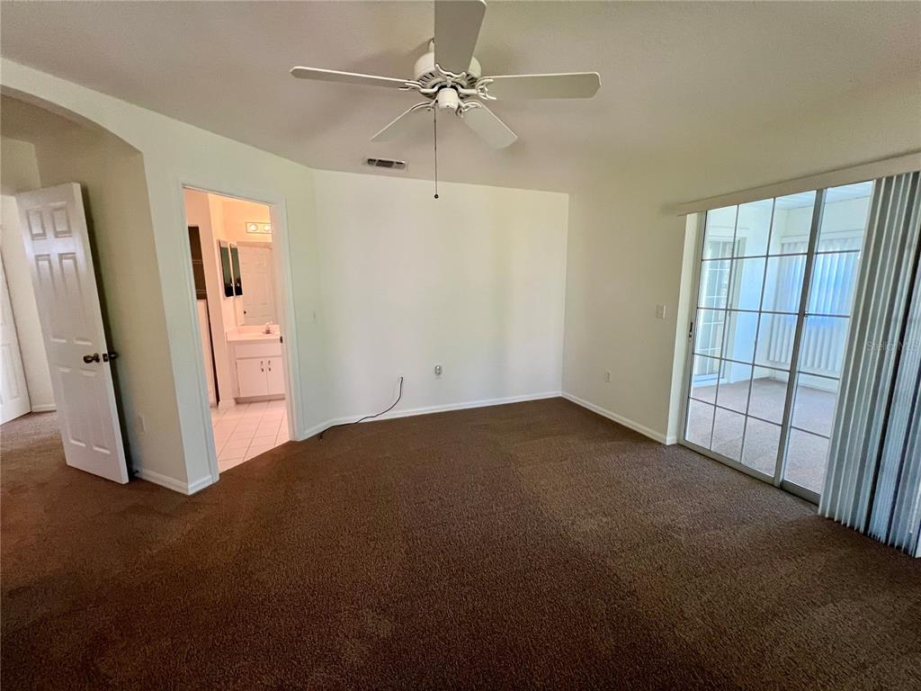 7205 Southwest 115th Place Ocala, FL 34476 - Photo 17 of 24 a view of empty room with ceiling fan