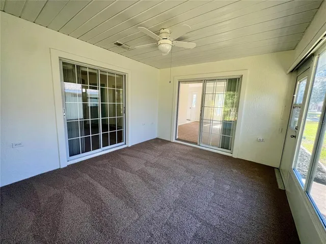a view of a kitchen with refrigerator and windows