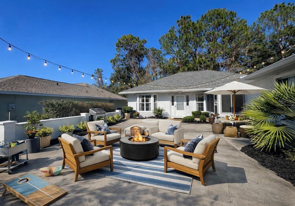 7205 Southwest 115th Place Ocala, FL 34476 - Photo 2 of 24 a outdoor living space with furniture and a fireplace