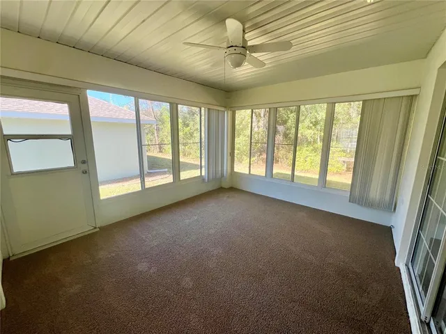 a view of house with a yard and plants
