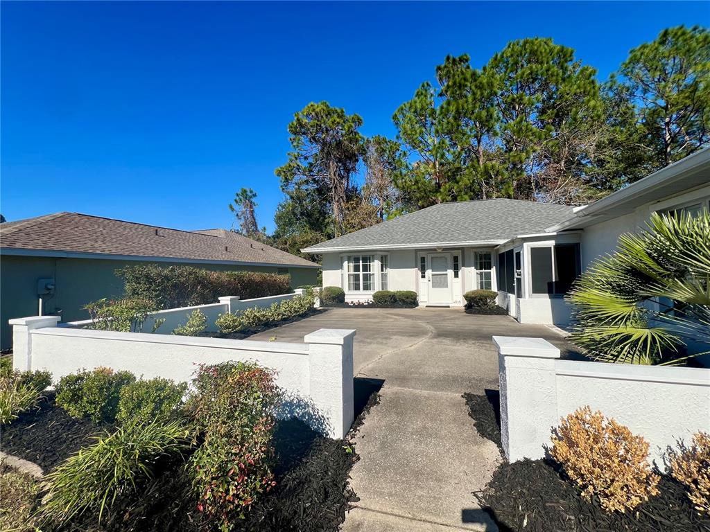 7205 Southwest 115th Place Ocala, FL 34476 - Photo 3 of 24 a front view of a house with garden