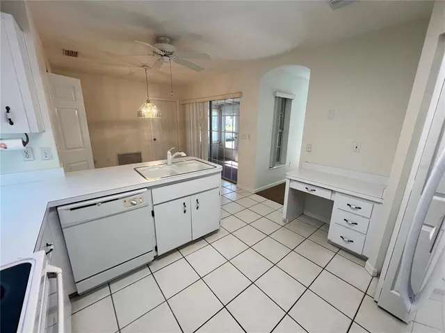 a kitchen with a sink cabinets and wooden floor