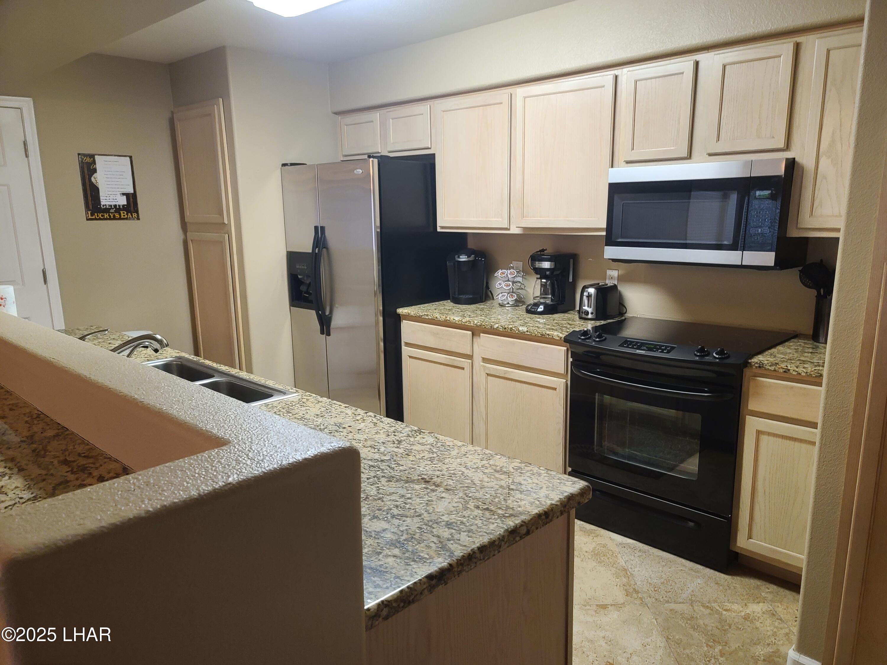 94 London Bridge Road, Unit 108 Lake Havasu City, AZ 86403 - Photo 30 of 38 a kitchen with a sink stove and refrigerator