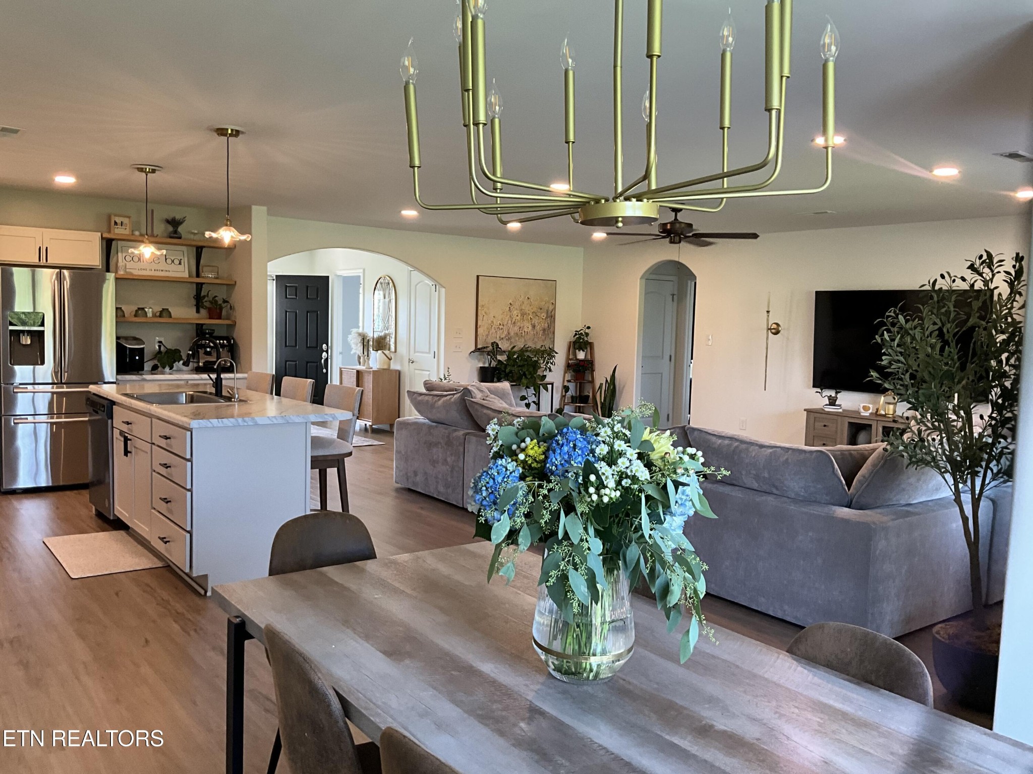 7921 Bud Hawkins Road Corryton, TN 37721 - Photo 5 of 24 a living room with furniture kitchen view and a chandelier