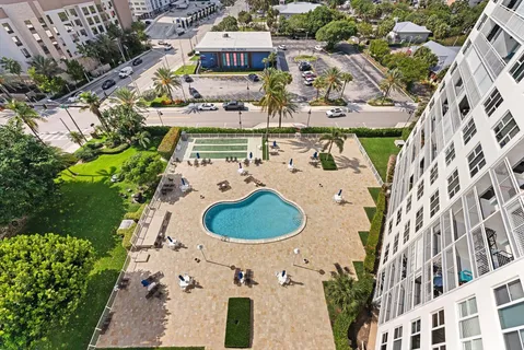 an aerial view of a house with a swimming pool patio and outdoor seating
