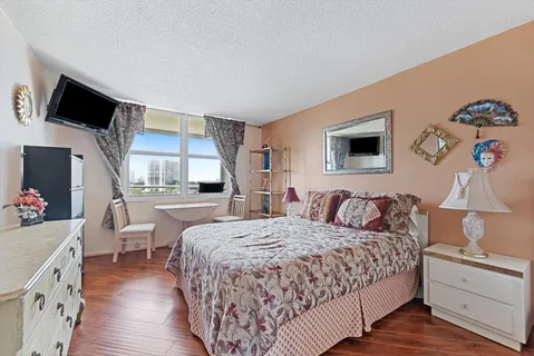 a bedroom with a bed and a flat screen tv