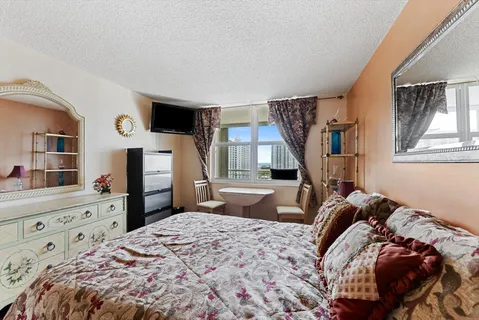 a bed room with a bed and a television