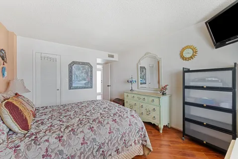 a bedroom with a bed and a television