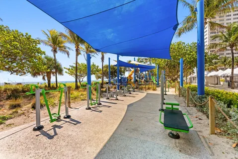 a view of a gym with plants and palm trees