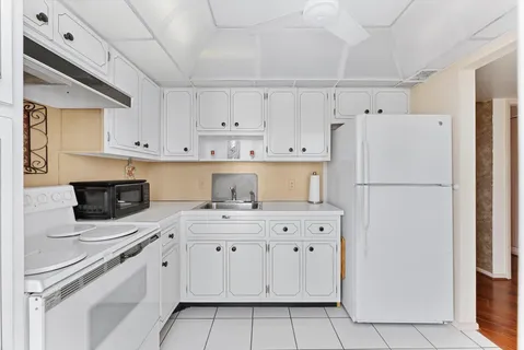 a kitchen with cabinets appliances and a sink