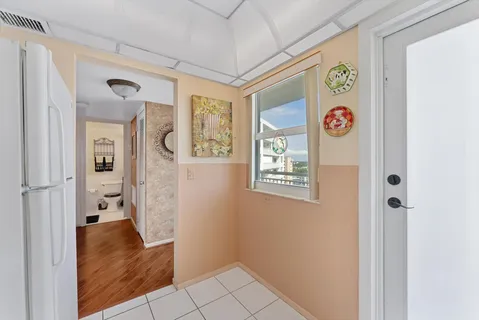 a view of a hallway with wooden shelves