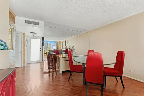 a dining room with furniture and wooden floor