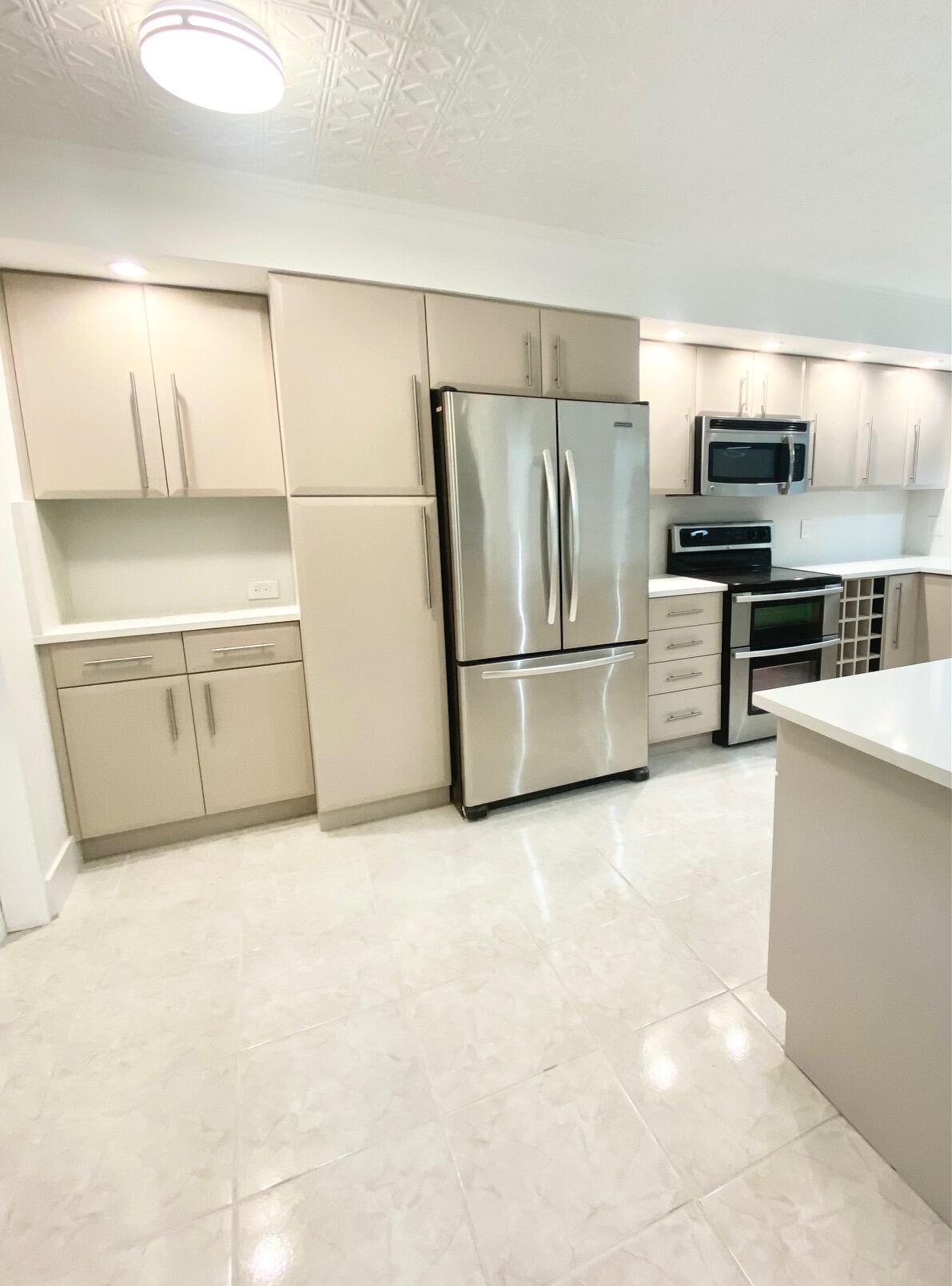 9170 Southwest 14th Street, Unit 4405 Boca Raton, FL 33428 - Photo 2 of 48 a kitchen with stainless steel appliances a refrigerator and a stove top oven