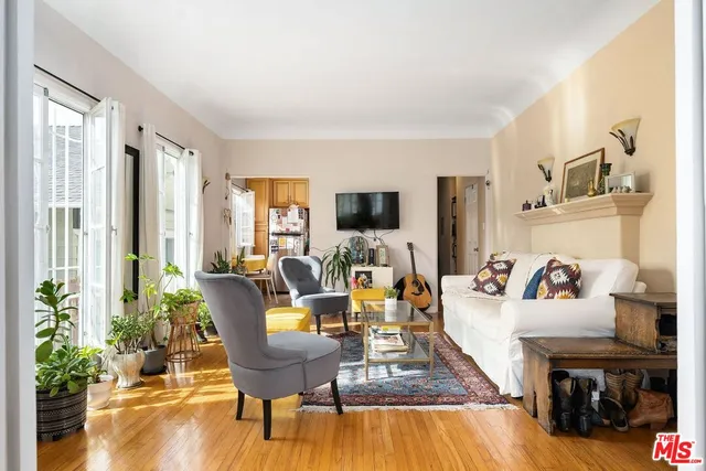 a living room with furniture and flowers
