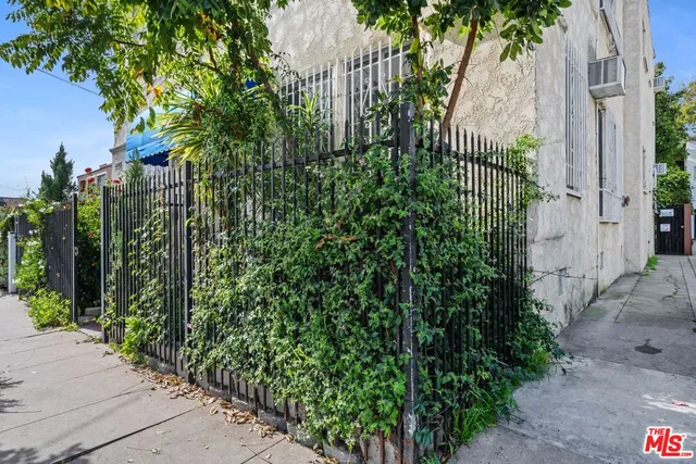 a view of a house with a small yard and plants
