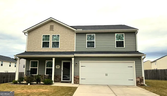 a front view of a house with garden
