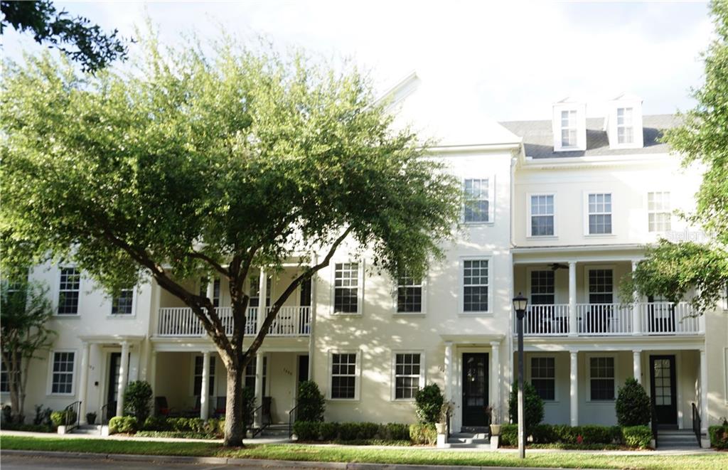 a view of a white building among the tree