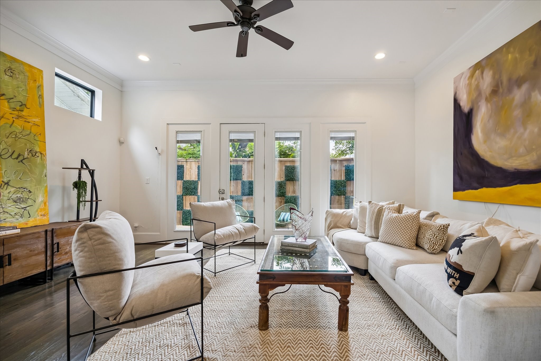 1208 Welch Street Houston, TX 77006 - Photo 10 of 35 The first floor has wonderful high ceilings and deep crown moulding. The windows beyond lead to the back patio and small yard. Being accessible from the main living space it's going to get a ton of use!
