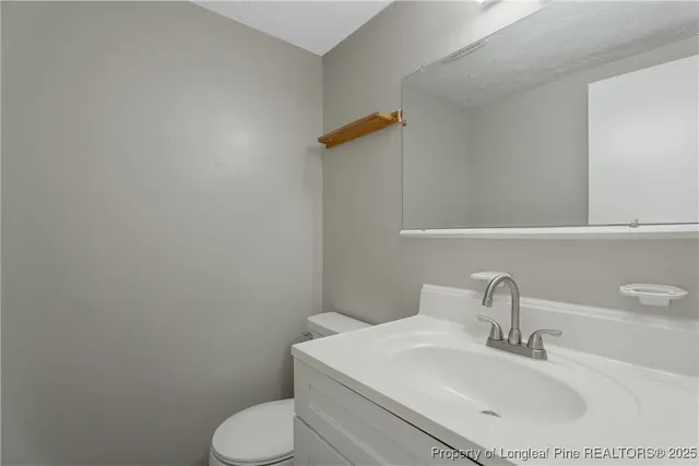 a bathroom with a sink toilet and mirror