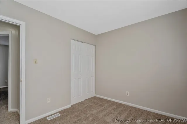 a view of a brick house with many windows