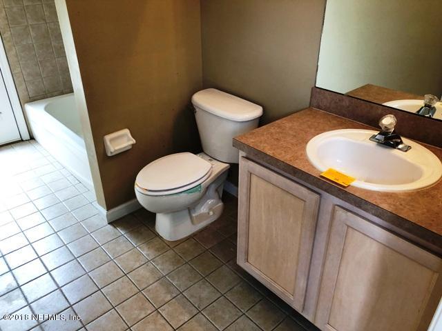 12067 Spring Ridge Drive Jacksonville, FL 32258 - Photo 15 of 36 a bathroom with a sink and a toilet