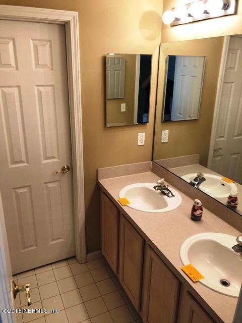 12067 Spring Ridge Drive Jacksonville, FL 32258 - Photo 17 of 36 a bathroom with a sink vanity and a mirror