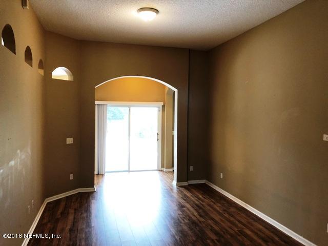 12067 Spring Ridge Drive Jacksonville, FL 32258 - Photo 2 of 36 an empty room with wooden floor and windows