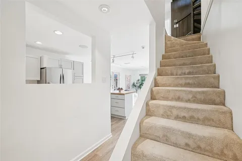 a view of staircase with white walls