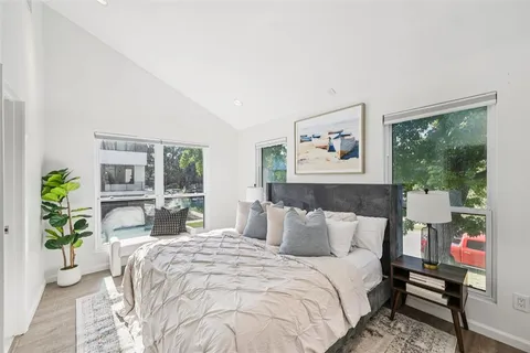 a bedroom with furniture and a large window