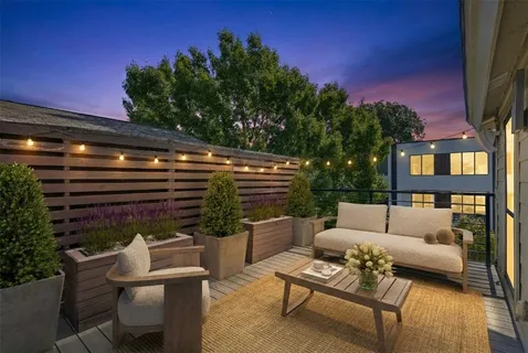 a view of a patio with couches table and chairs and potted plants with sky view