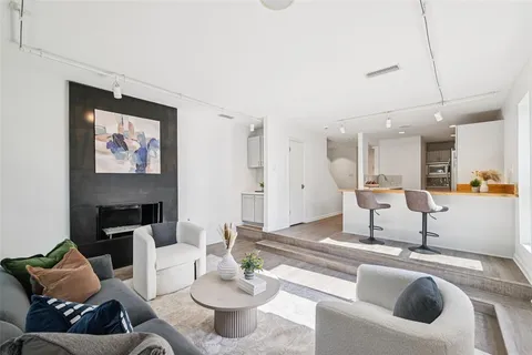 a living room with furniture and kitchen view