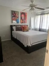 a bedroom with a bed and a painting on the wall