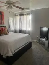 a bedroom with a bed and a flat screen tv