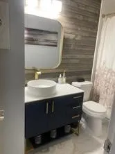 a bathroom with a sink toilet and mirror