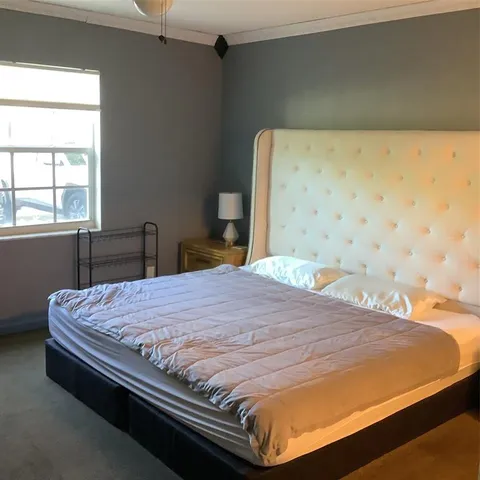 a bedroom with a bed and window