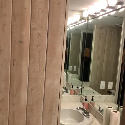 a bathroom with a sink vanity and a mirror