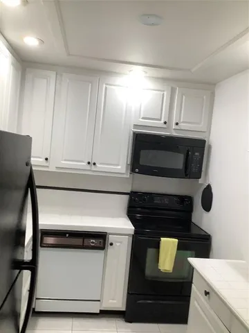 a kitchen with granite countertop a stove and a microwave