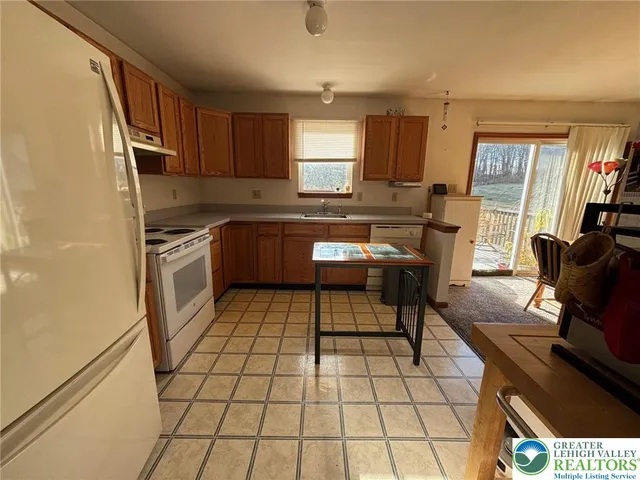 a kitchen with stainless steel appliances granite countertop a stove a sink and a counter top space