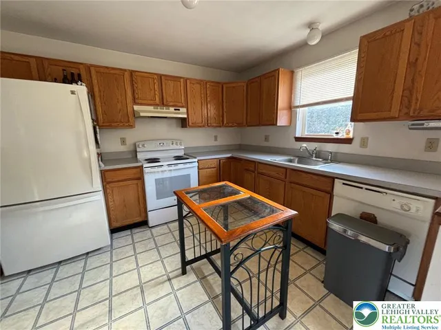a kitchen with appliances cabinets and a sink
