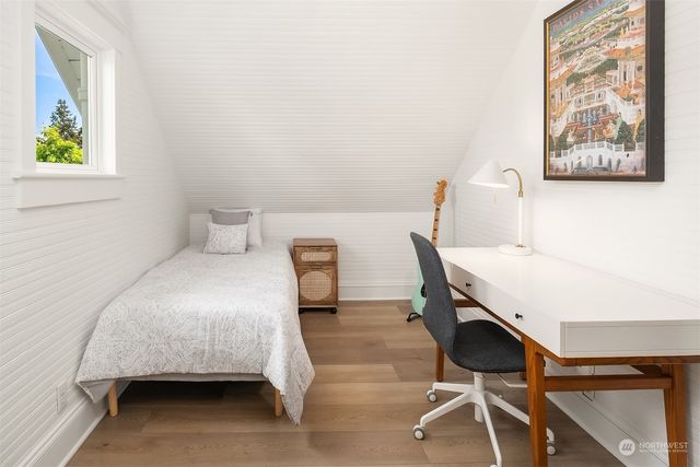 a bedroom with a bed and a table in it