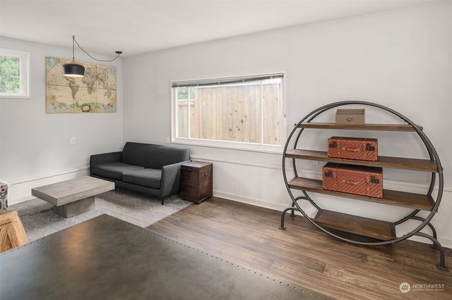 a living room with furniture a rug and a window