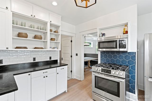 a kitchen with stainless steel appliances granite countertop a stove and a sink