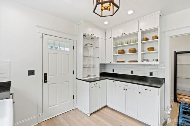 a kitchen with granite countertop a sink and cabinets