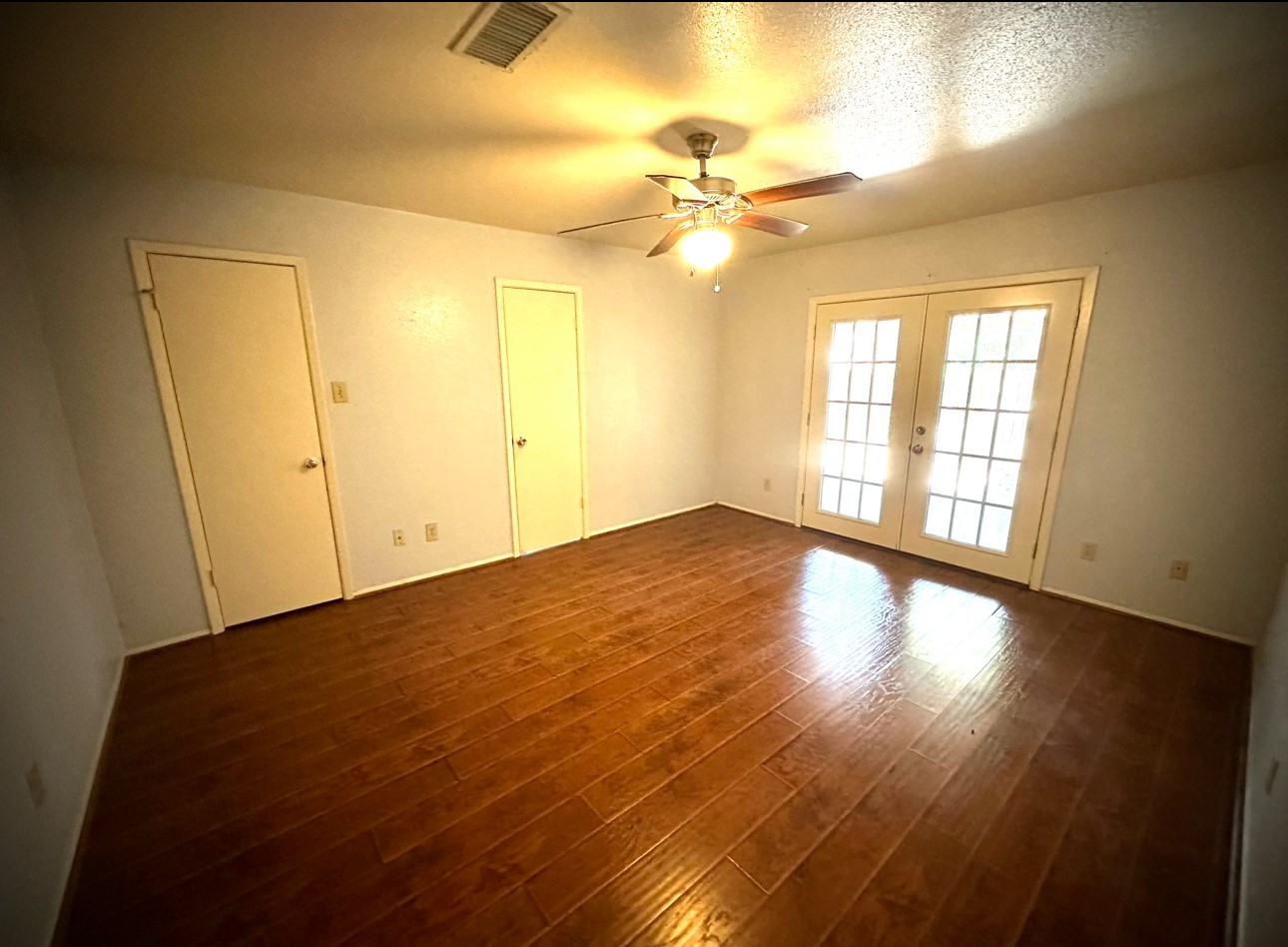 18 Brookflower Road The Woodlands, TX 77380 - Photo 11 of 23 Master Bedroom with double door to outdoor patio