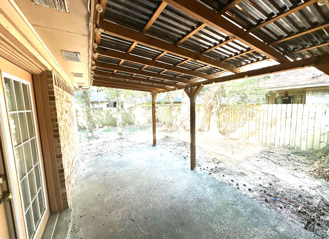 18 Brookflower Road The Woodlands, TX 77380 - Photo 20 of 23 Covered patio with lights real cozy at night out here!